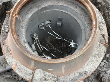 Man hole with conduit and mule tape place. Ready to pull in fiber.