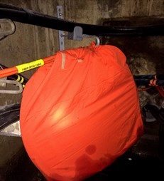 Excess fiber coiled inside fire bag